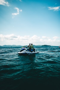 People are riding a jet ski on the ocean.