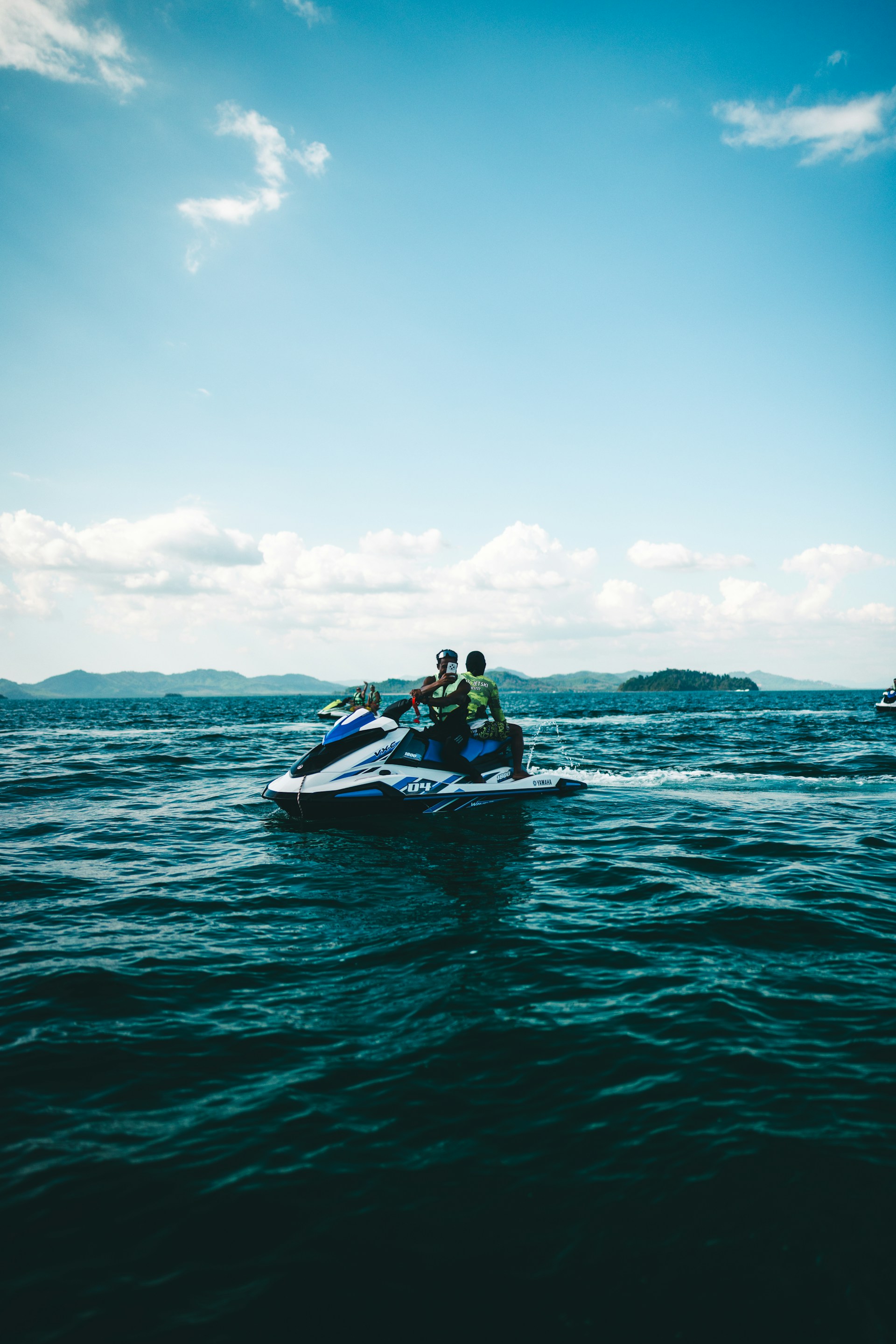 People are riding a jet ski on the ocean.