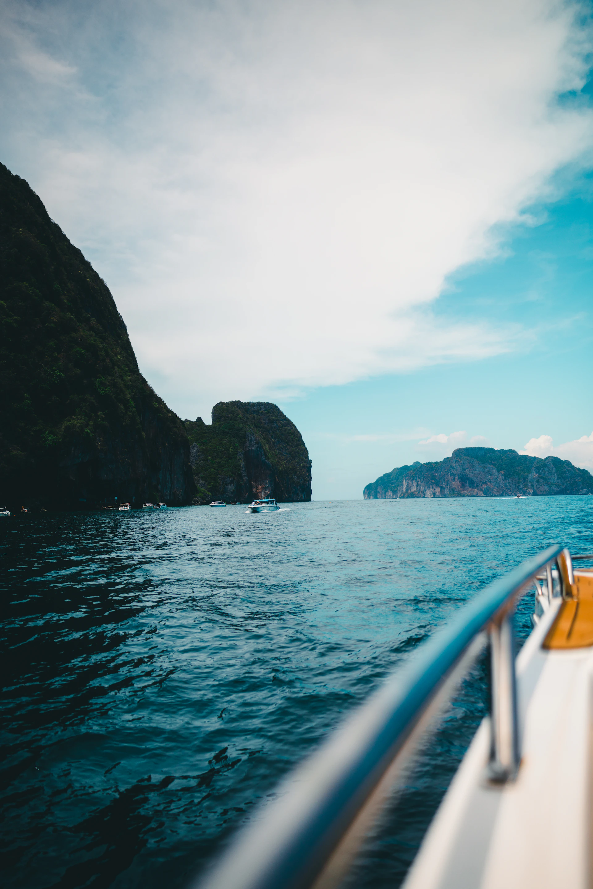 Boat ride through turquoise water, island views.
