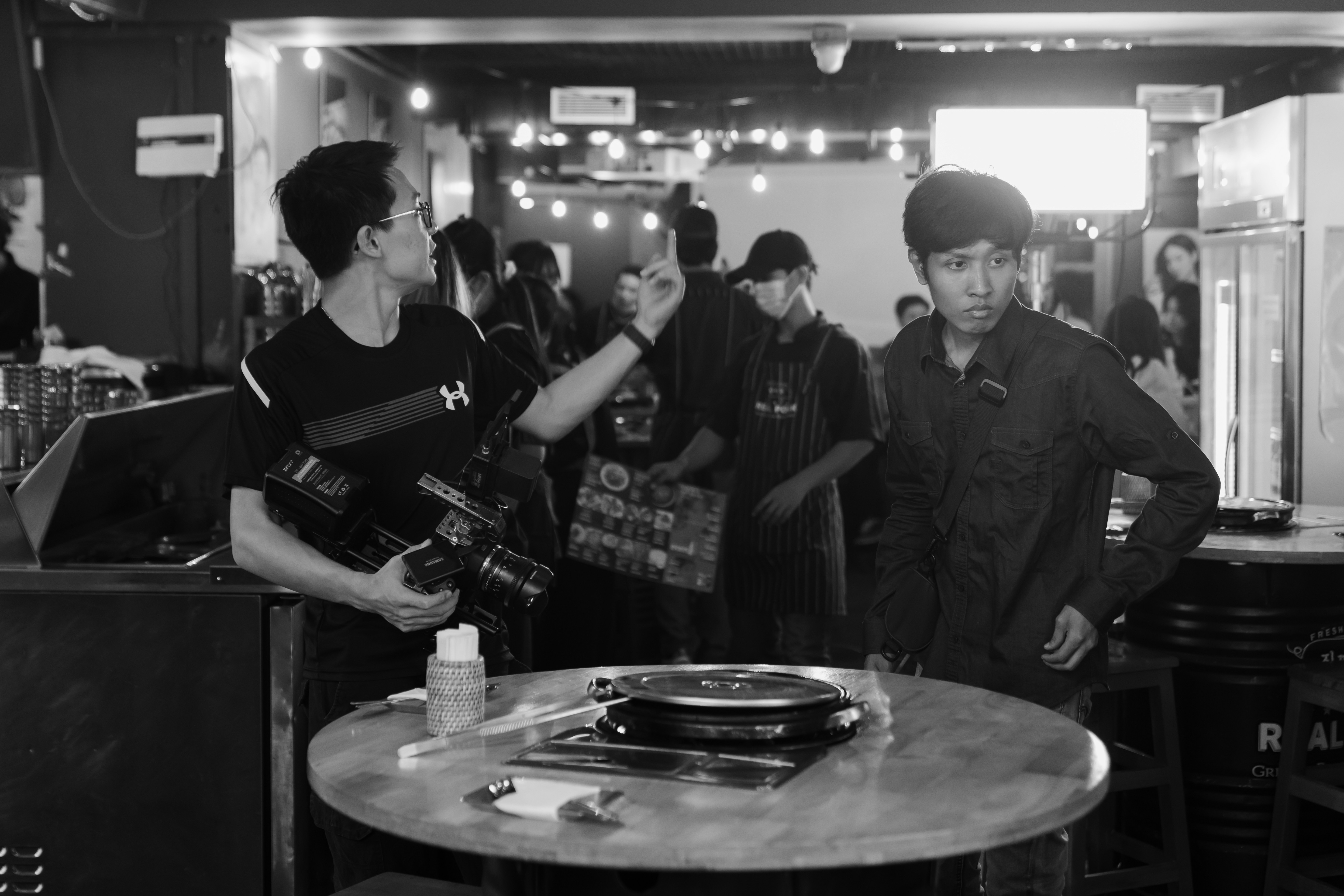 Filming a scene in a bustling bar.