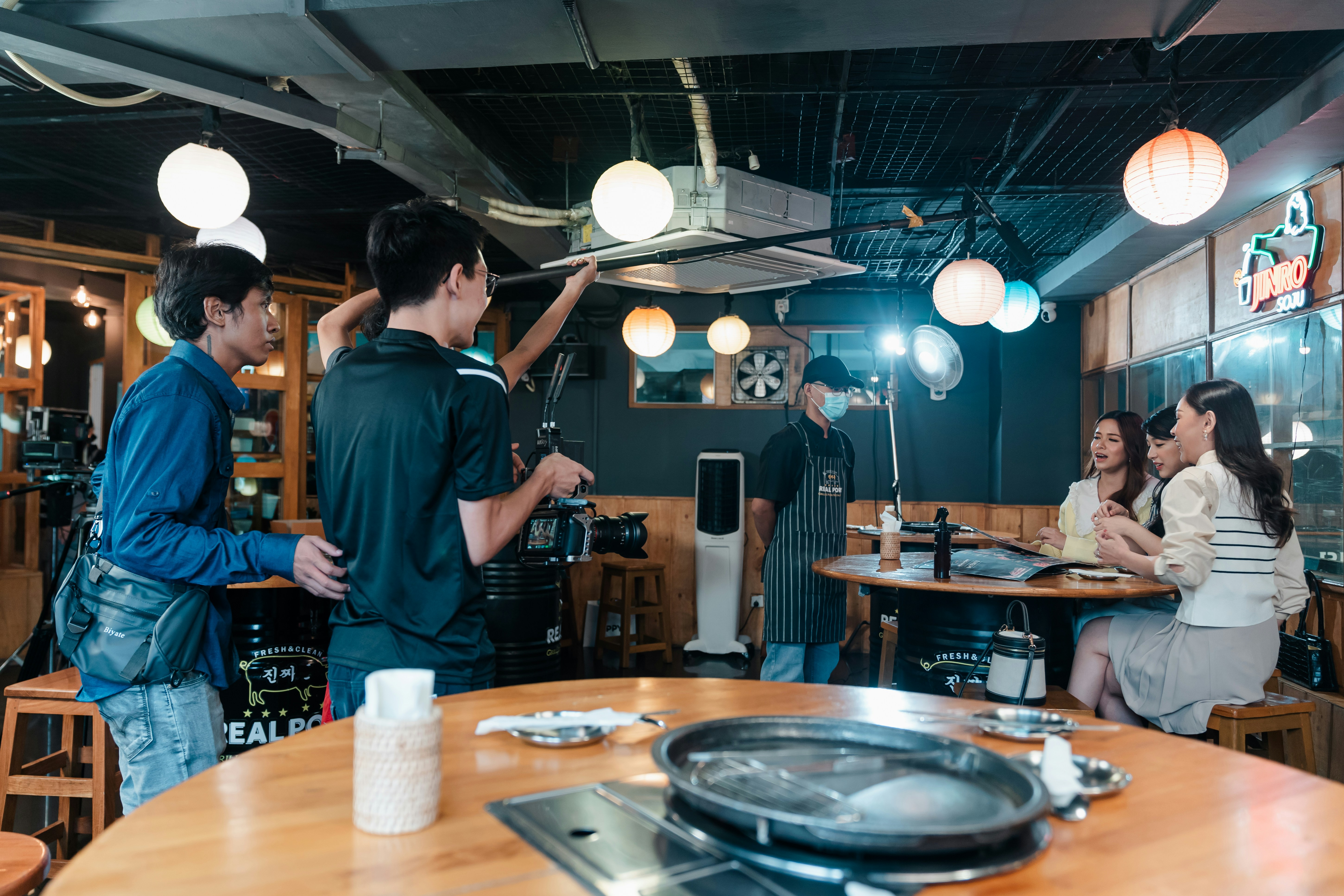 A film crew is shooting inside a restaurant.