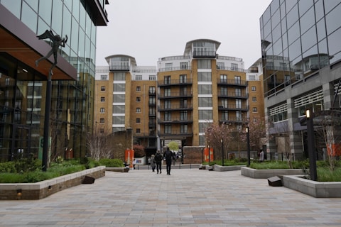 Modern buildings stand in an open urban plaza.