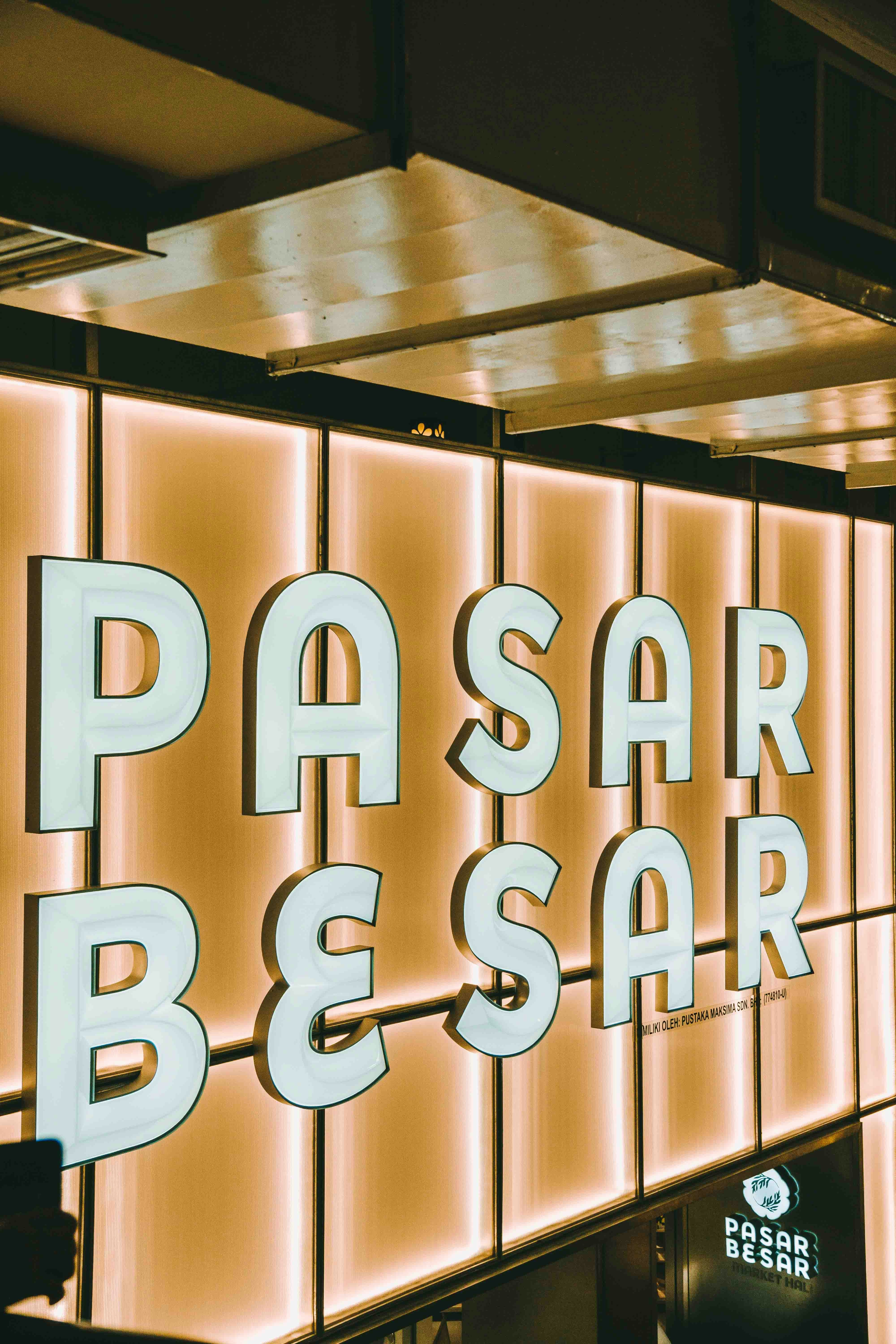 The sign reads "pasar besar" in bright lights.