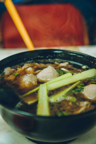 A steaming bowl of noodle soup, evocative of a tsukemen dish
