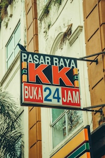 A store sign that says "pasar raya kk."