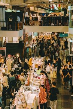 People shop and browse at a bustling marketplace.