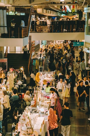 People shop and browse at a bustling marketplace.