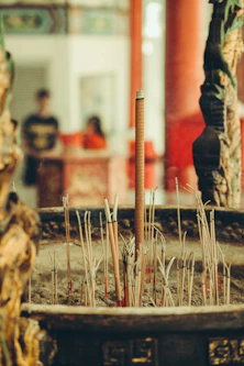 Incense sticks burn at an asian temple.
