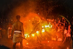 Ritual performance with fire and figures at night.