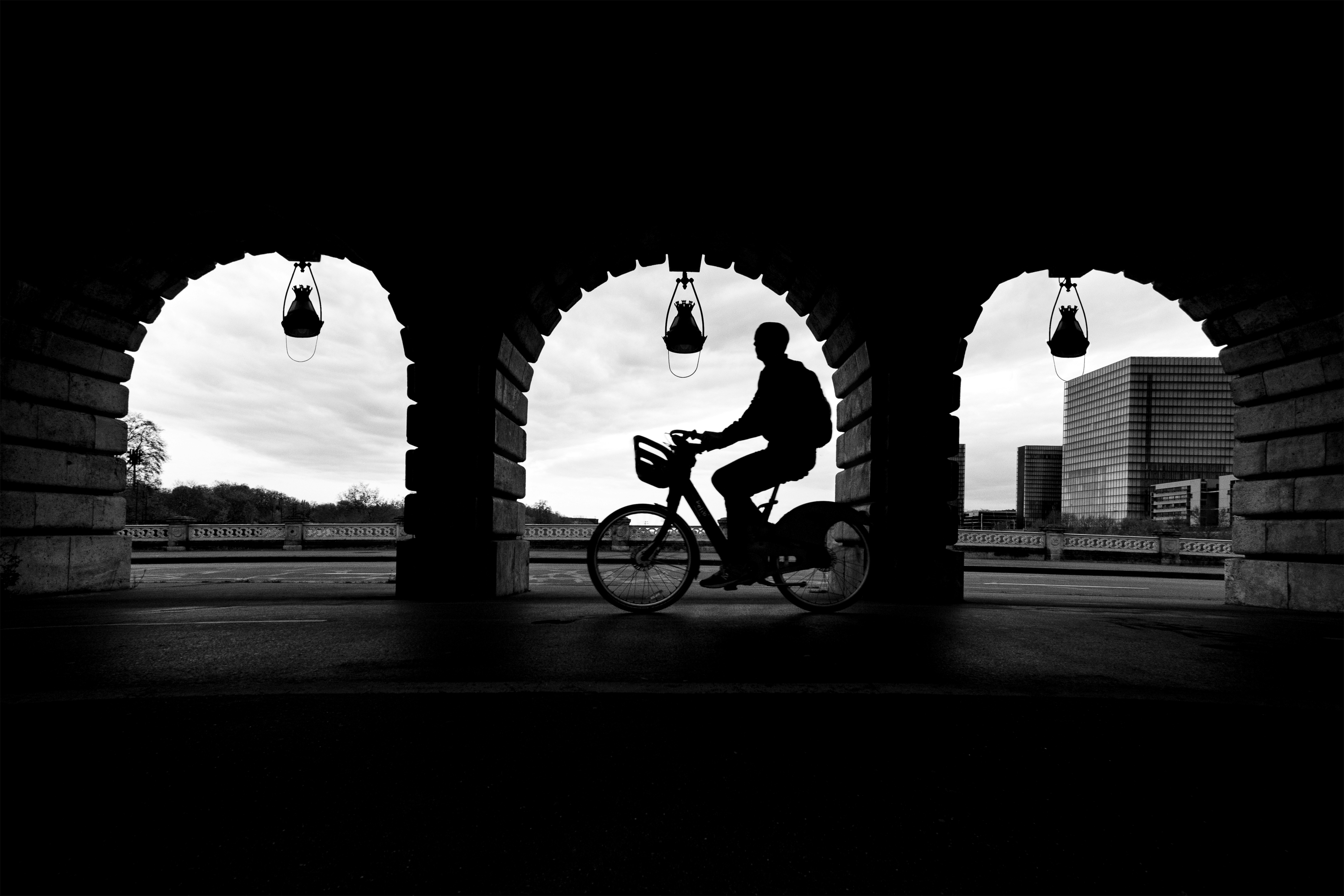 Silhouette of a person riding a bike.