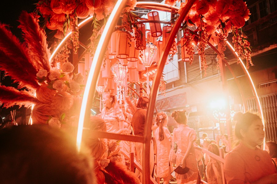 People under red lanterns at a night market in Chiang Mai