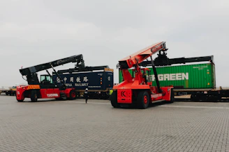 Forklifts unload cargo containers from trains.