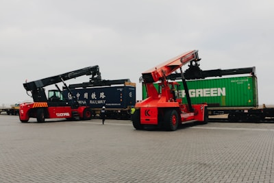 Forklifts unload cargo containers from trains.