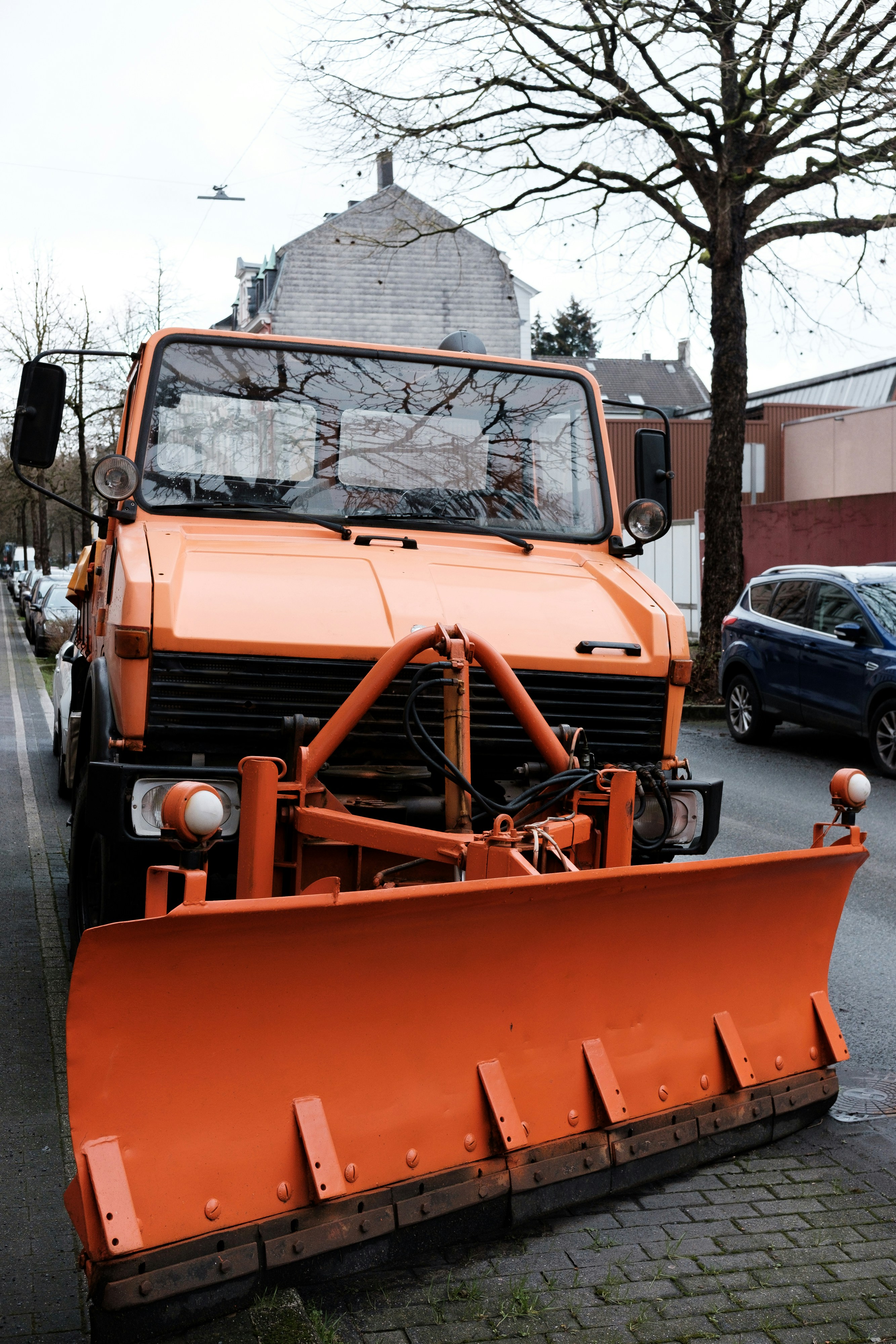 A snowplow is ready to clear the street.