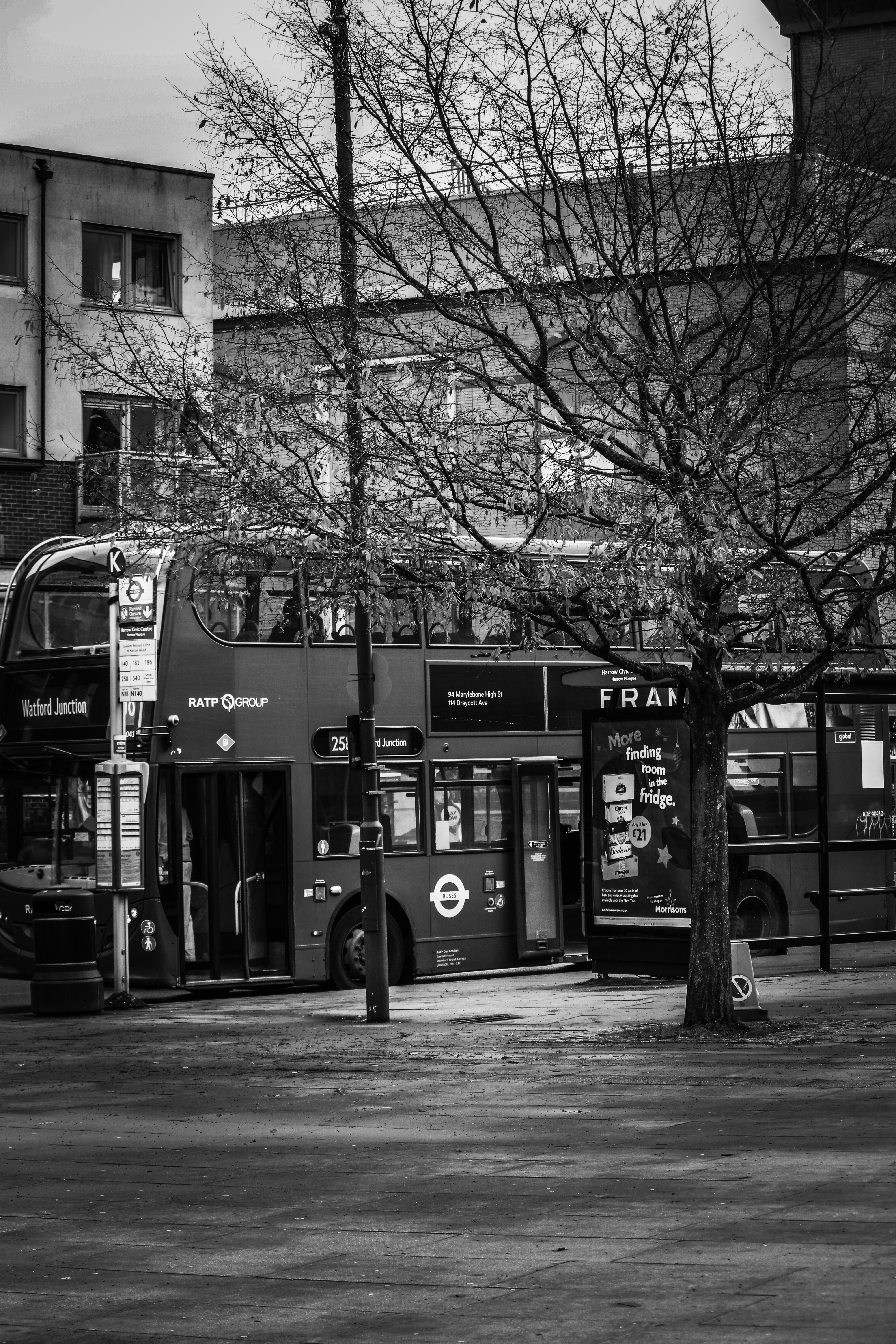 A double-decker bus parked by a street.