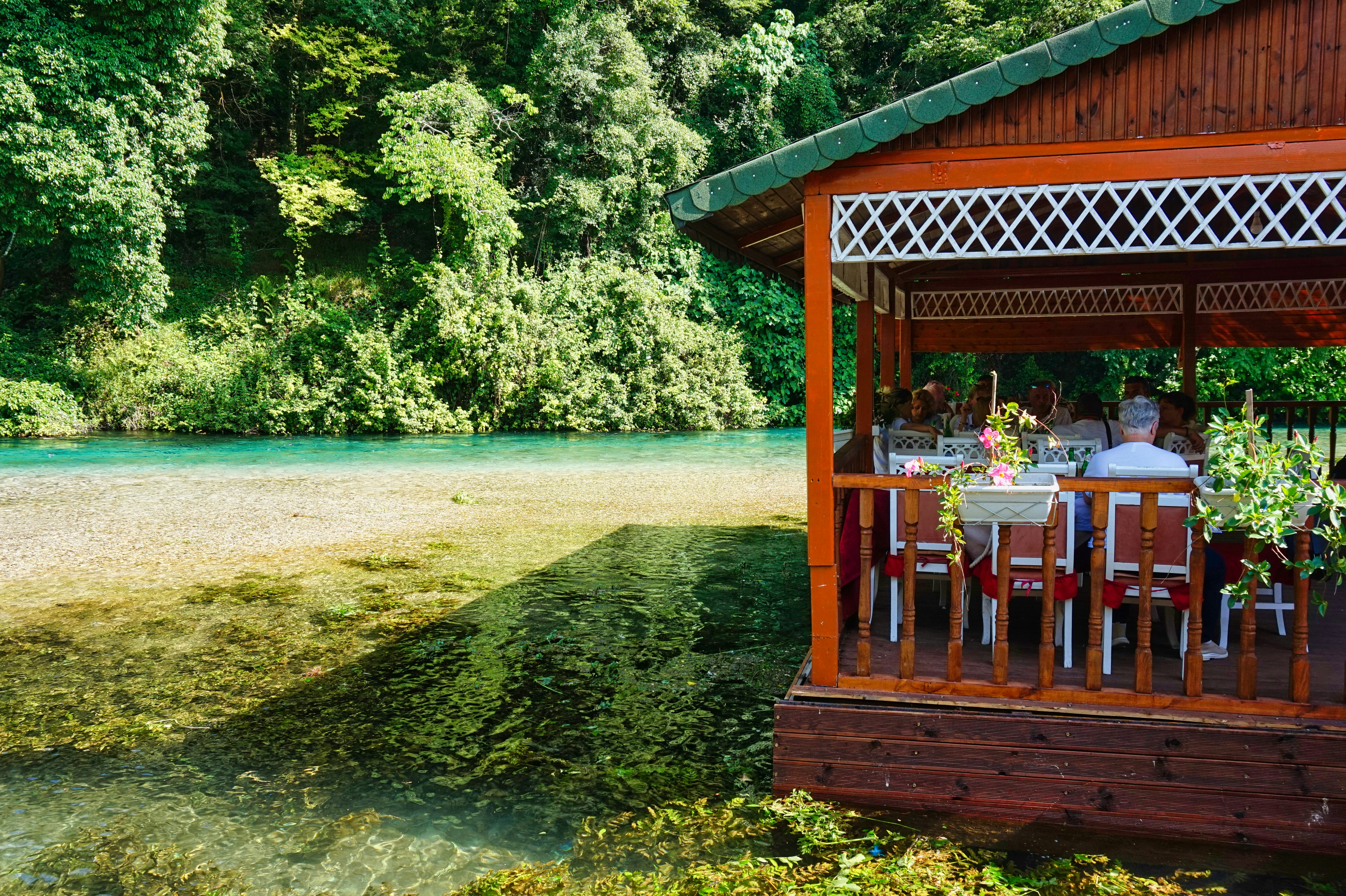 A restaurant is located next to a beautiful river.