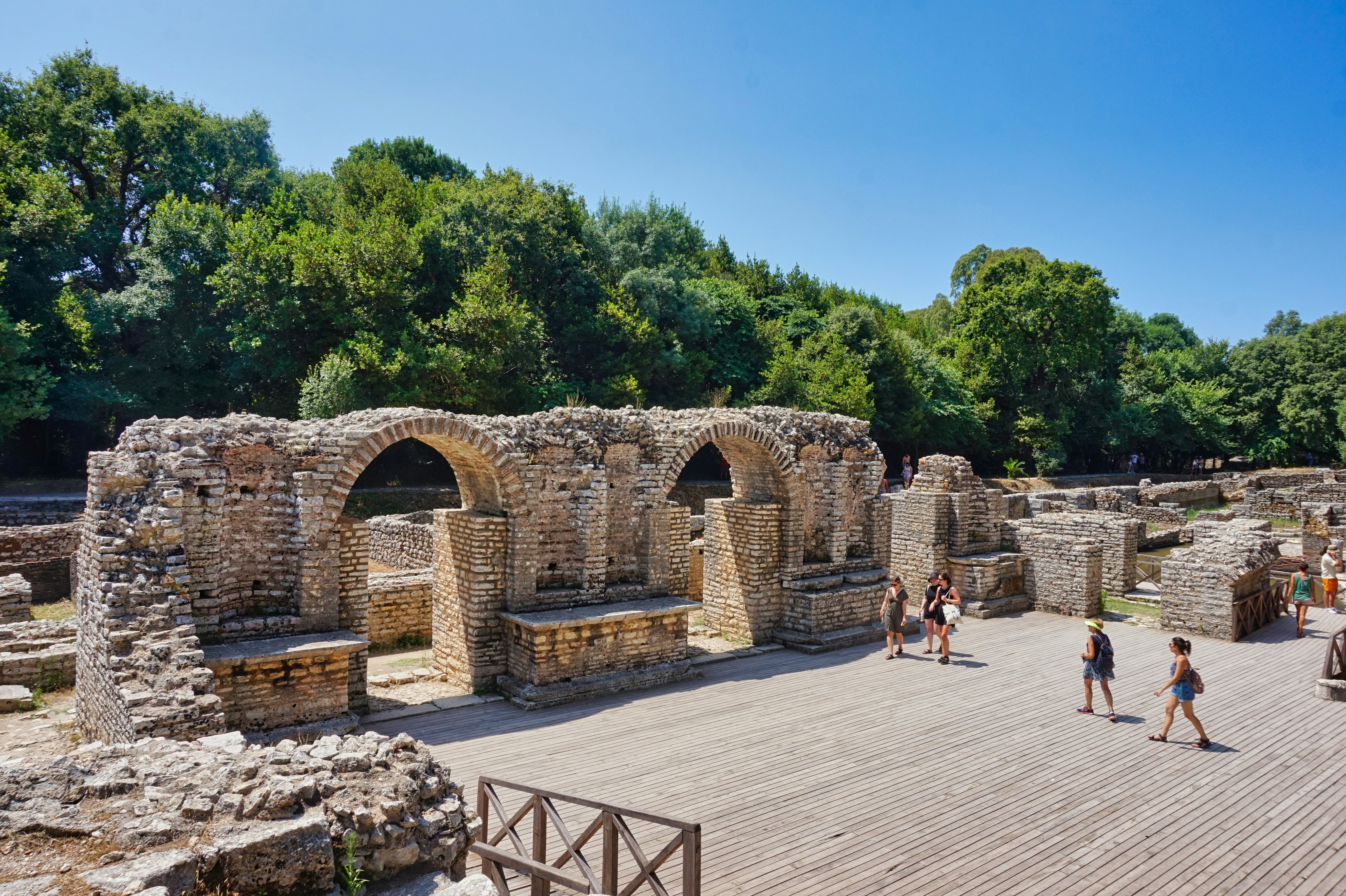Ruins of an ancient building with some visitors.