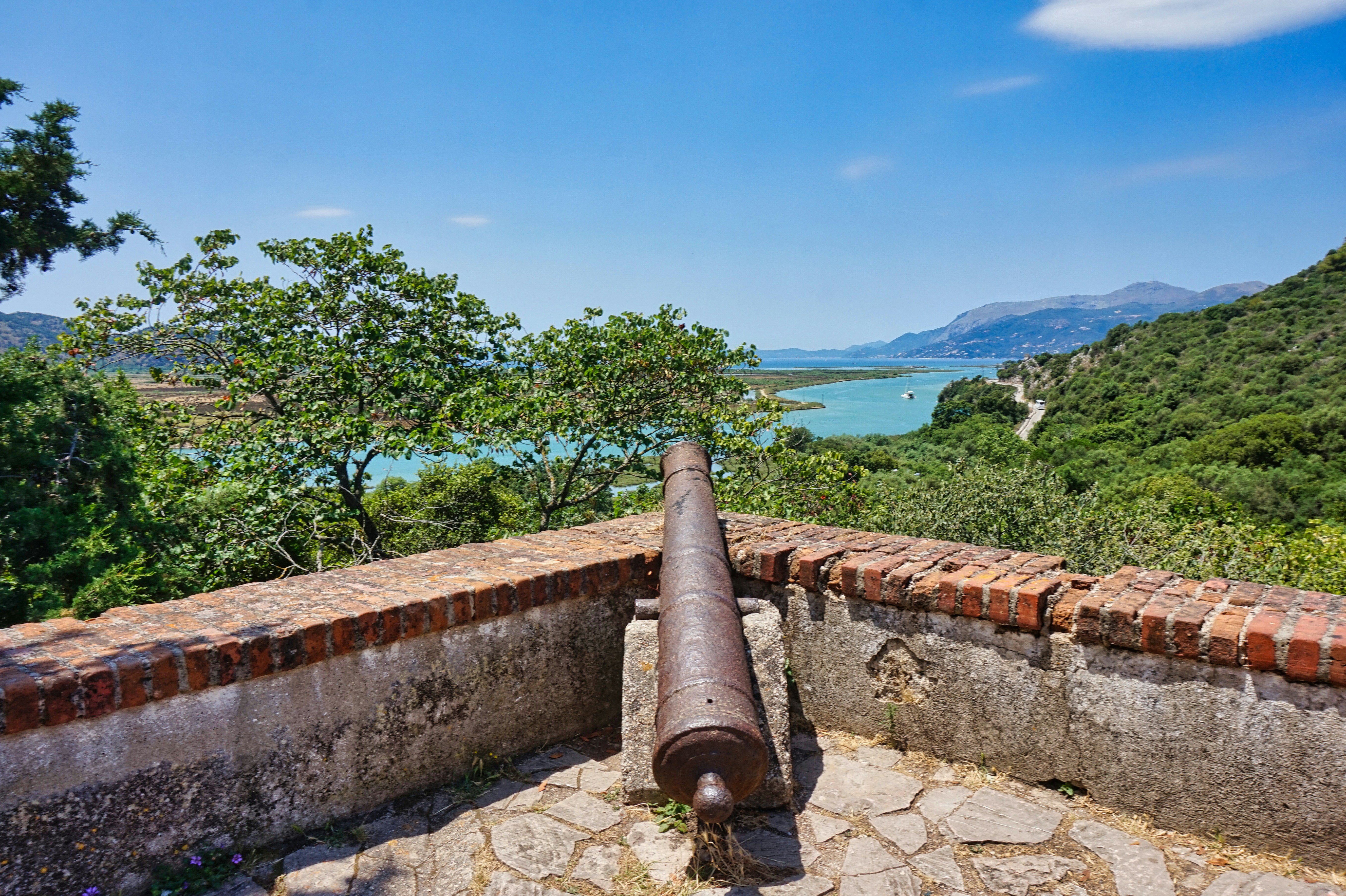 A cannon overlooks a scenic landscape.