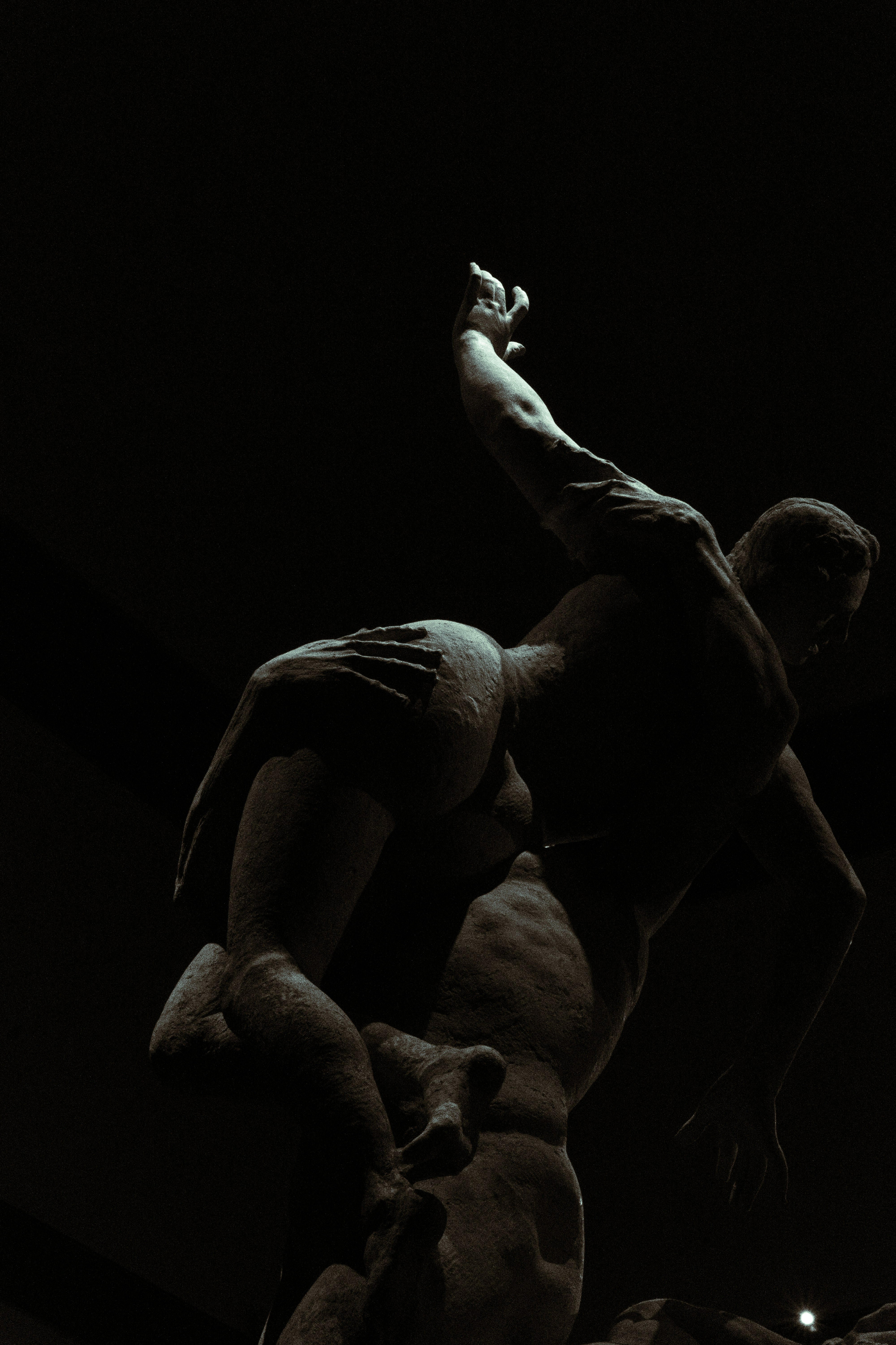 Sculpture depicting two men locked in struggle.