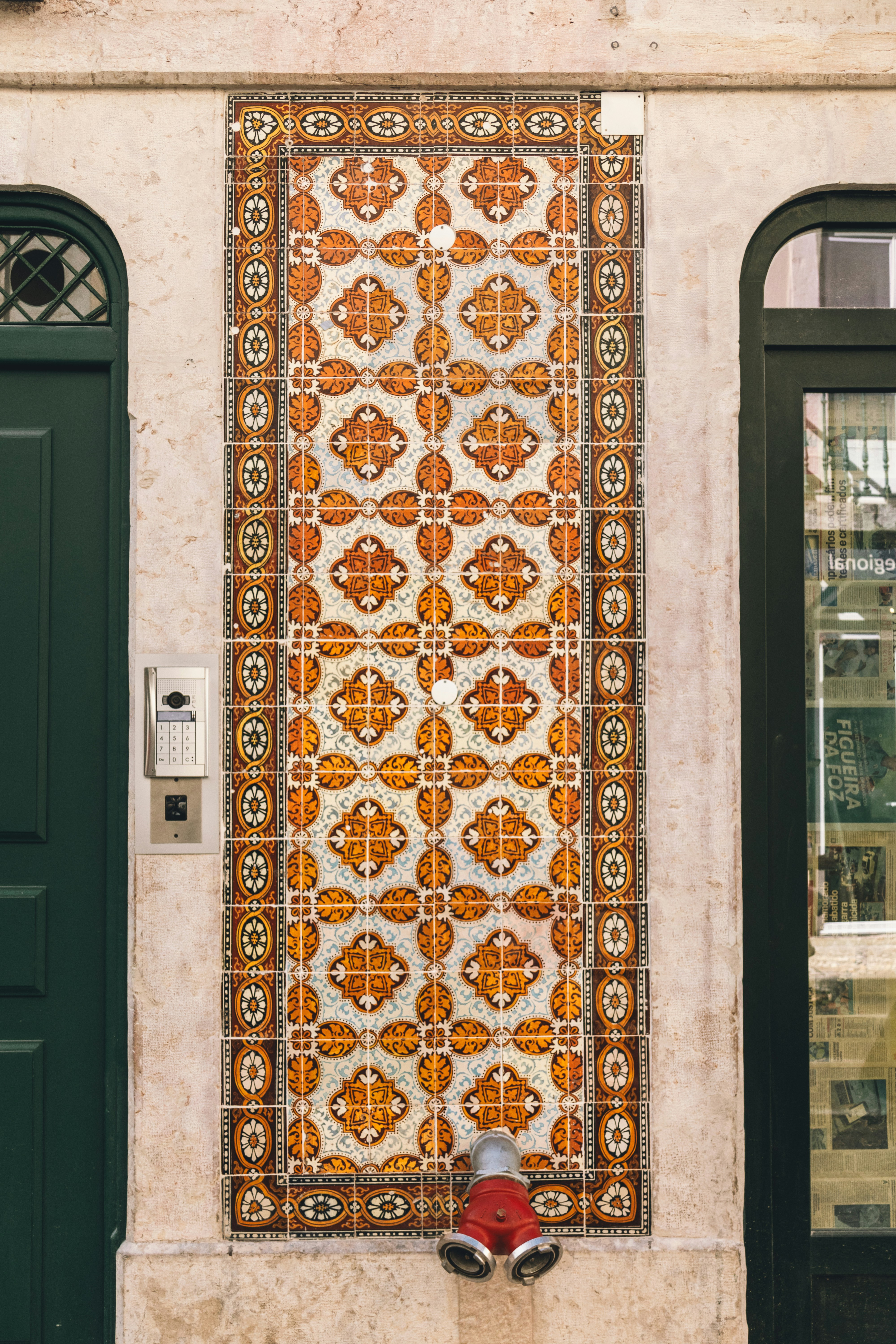 Colorful tiles adorn a building's exterior.