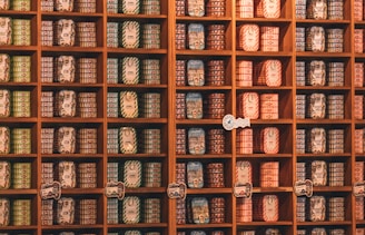Shelves are stocked with many preserved food cans.
