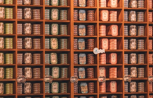 Shelves are stocked with many preserved food cans.
