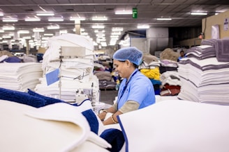A woman works at a textile factory.