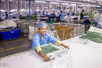 Woman works in a clothing manufacturing facility.