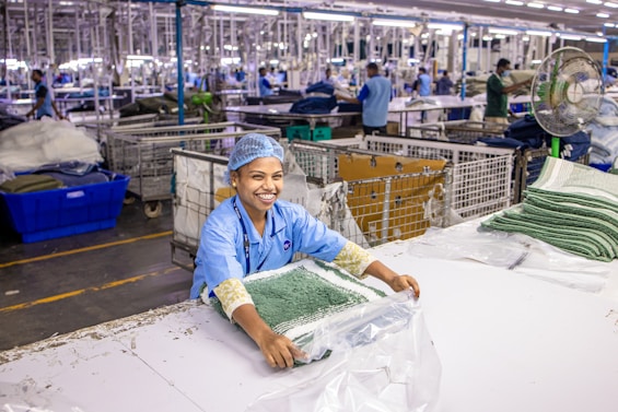 Woman works in a clothing manufacturing facility.