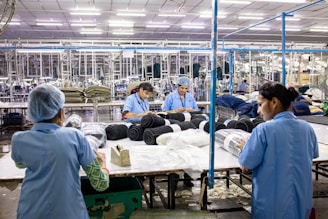 Workers are packaging textiles in a factory.