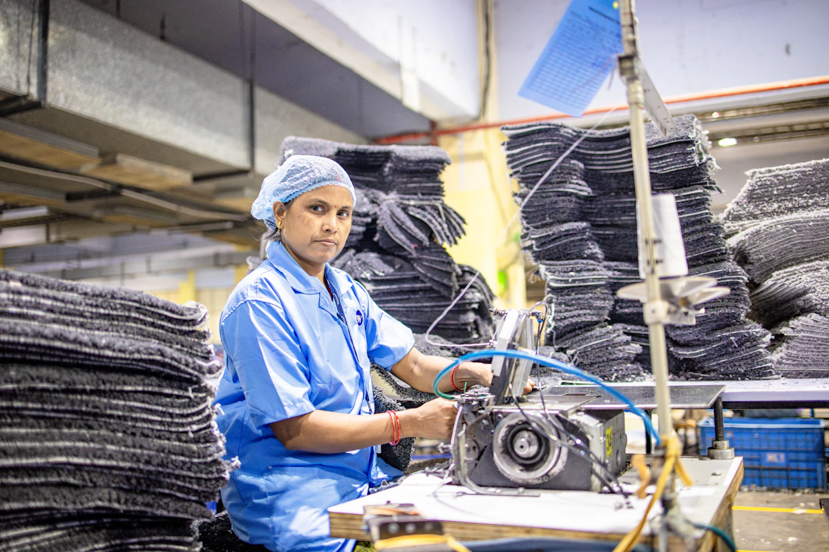 Worker using a sewing machine in a garment factory