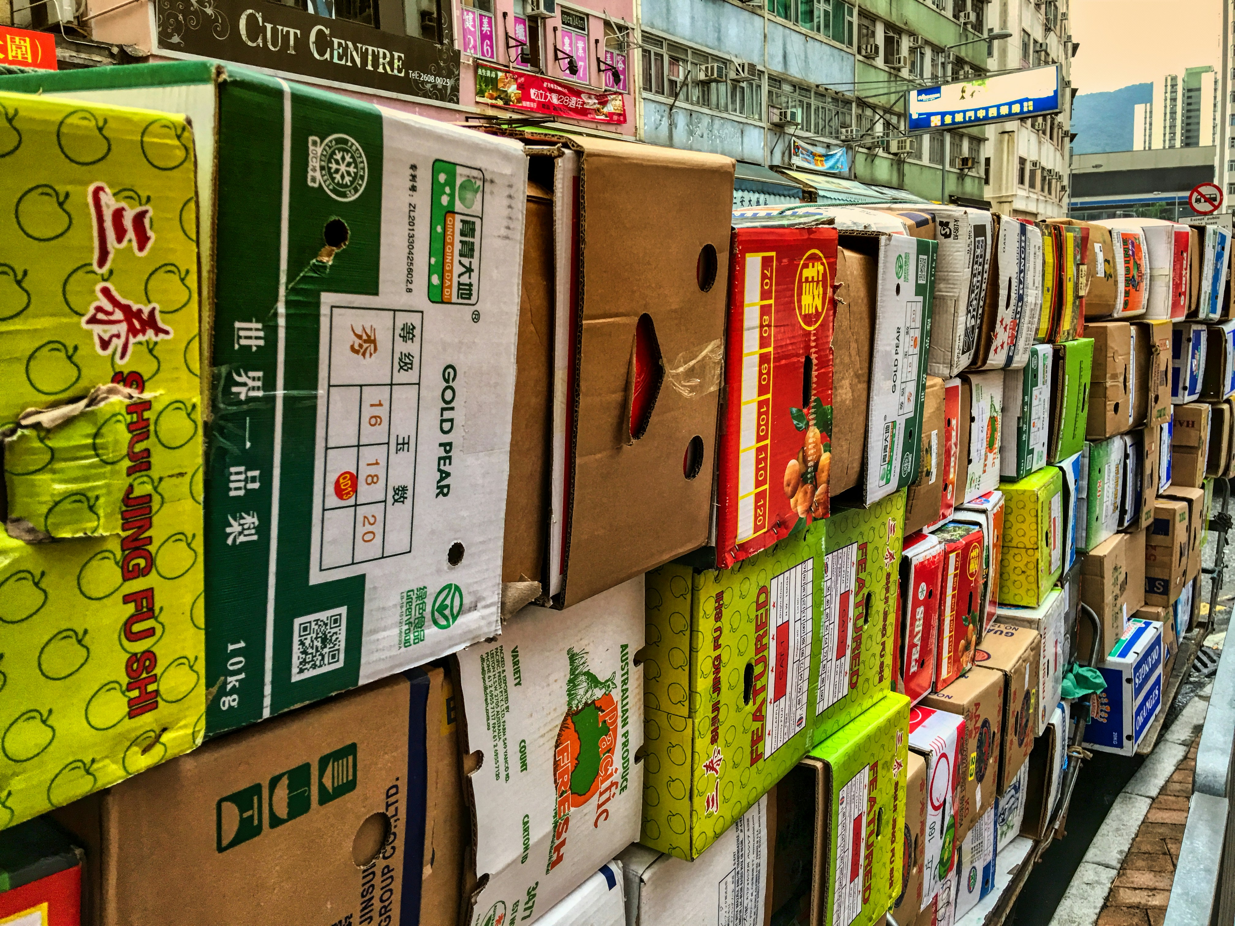 Boxes are stacked against a city street.