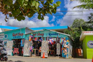 Colorful gift shops sit on the roadside.