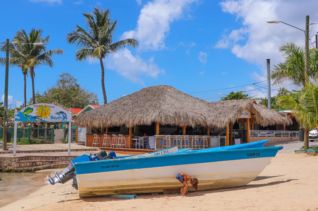 Beach bar and boat under a sunny Caribbean sky