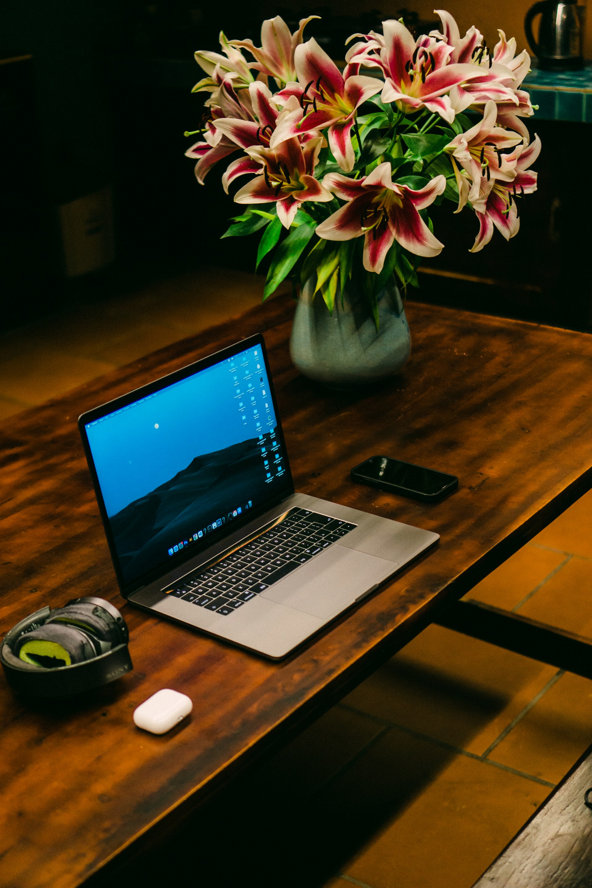 Laptop and lilies create a relaxing workspace.