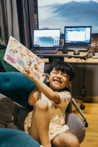 Happy child shows off his colorful puzzle.