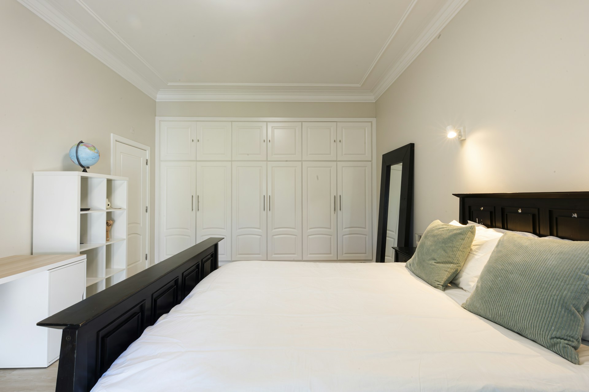Bedroom with large bed and built-in wardrobe.
