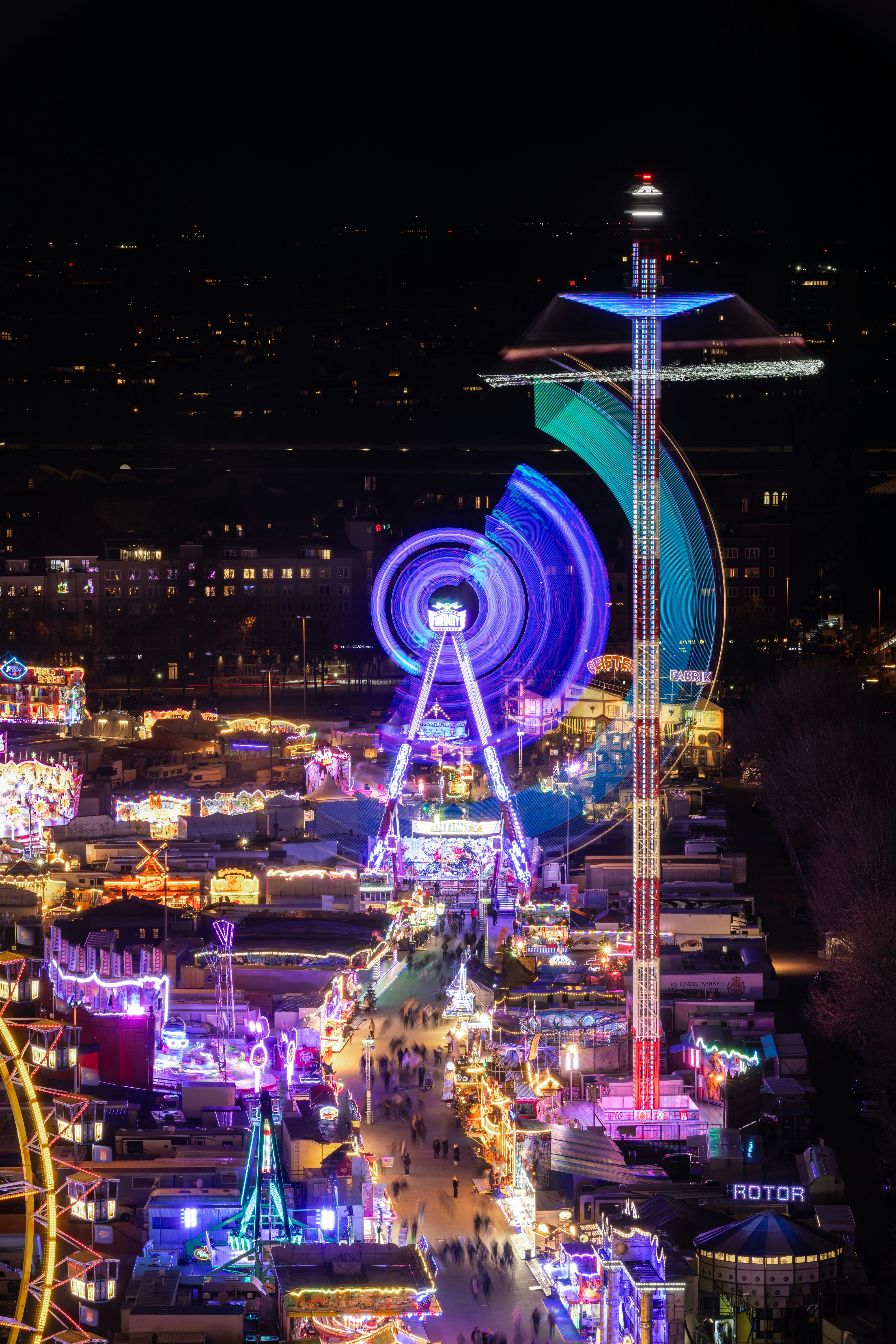 A lit-up amusement park at night.