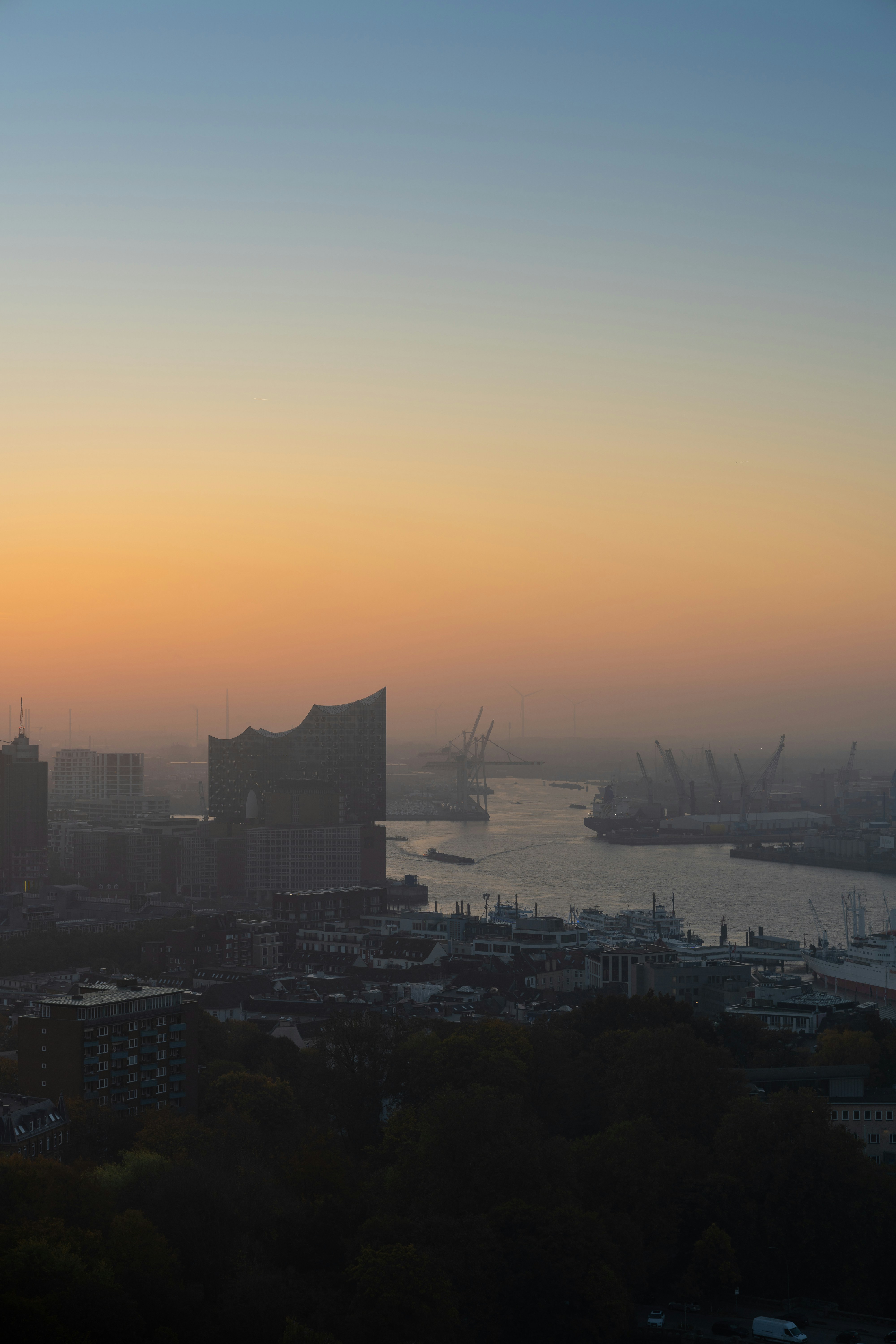 City skyline silhouetted at a colorful sunrise.