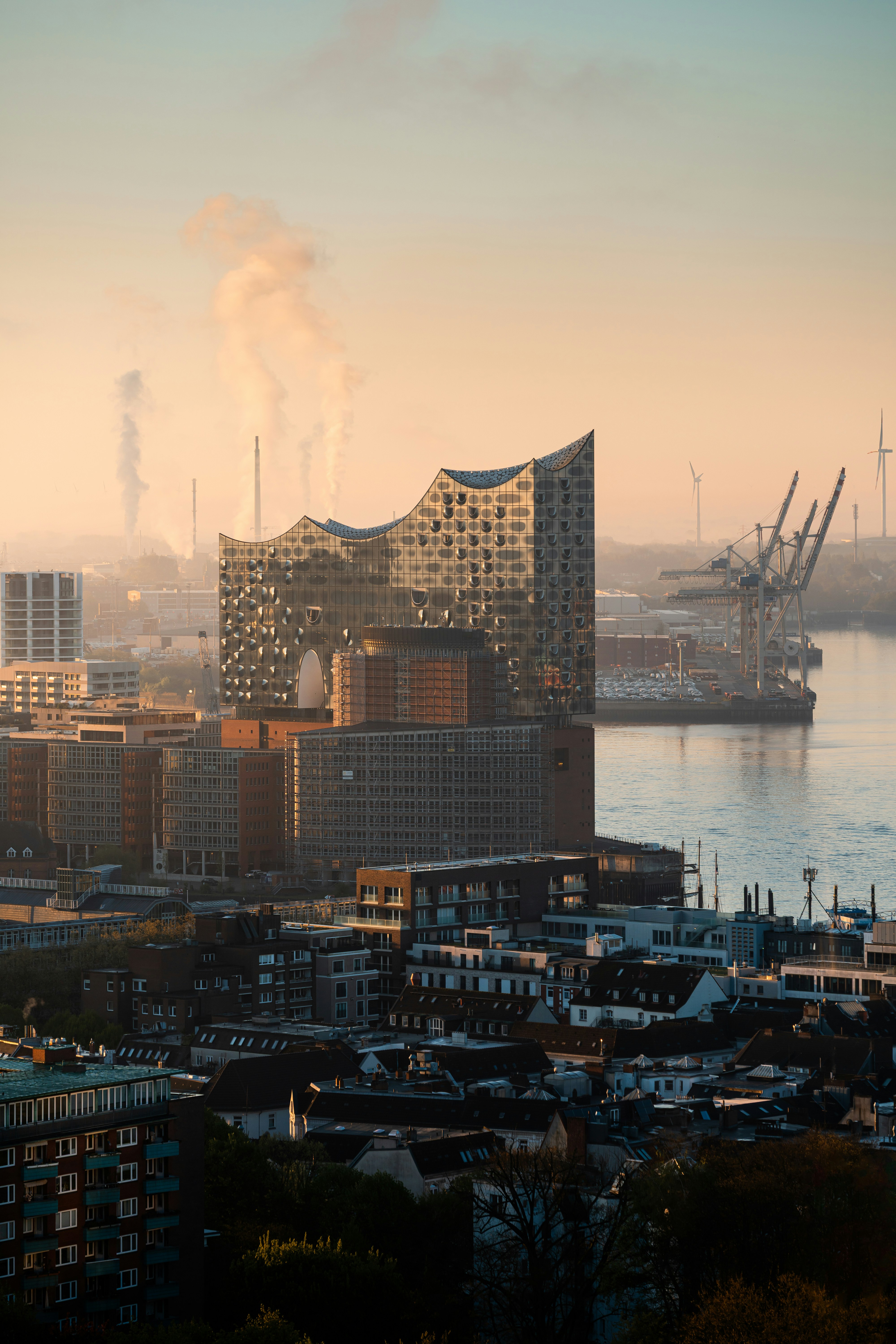 The elbphilharmonie concert hall sits on the river.