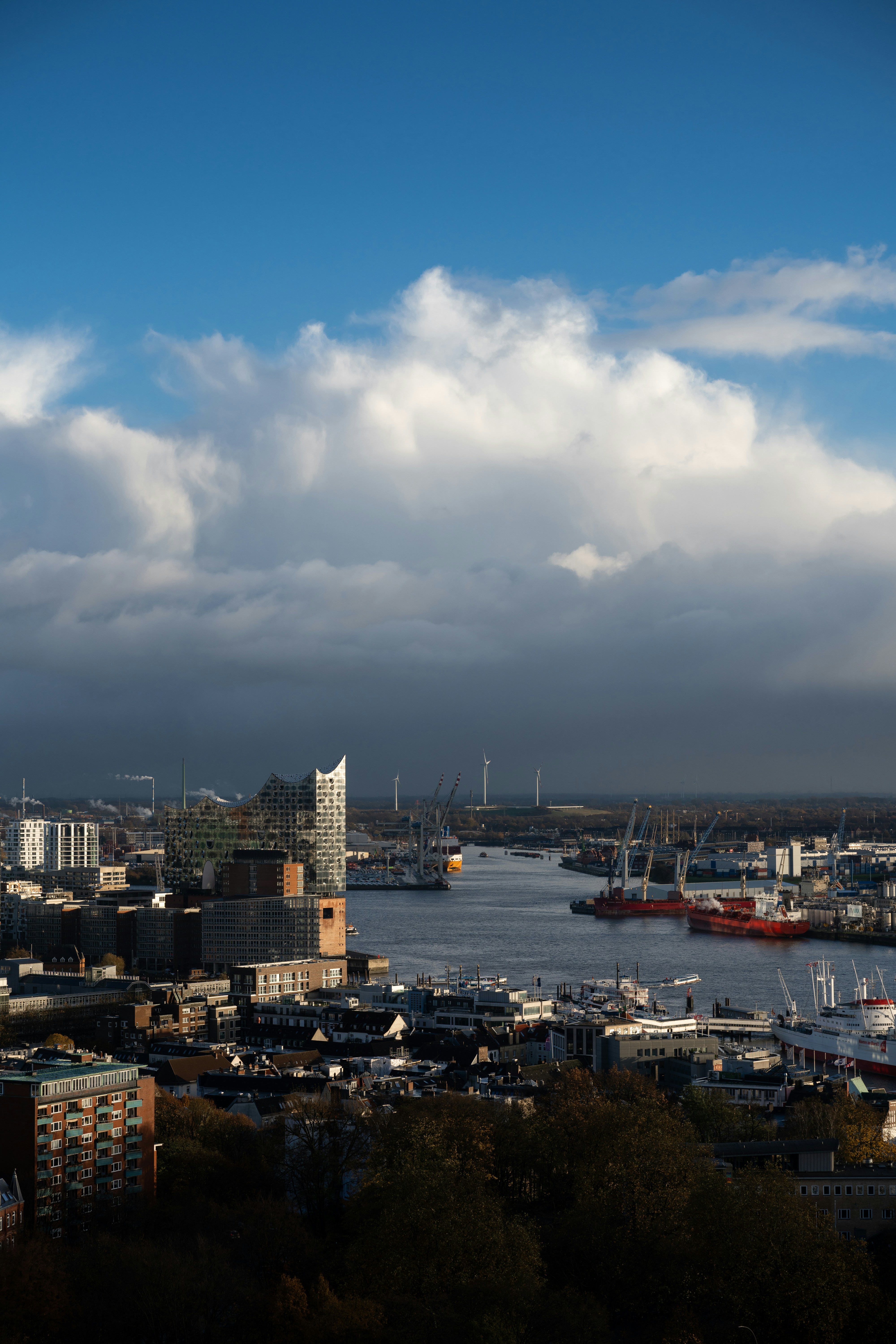 Cityscape view with a river and cloudy sky.