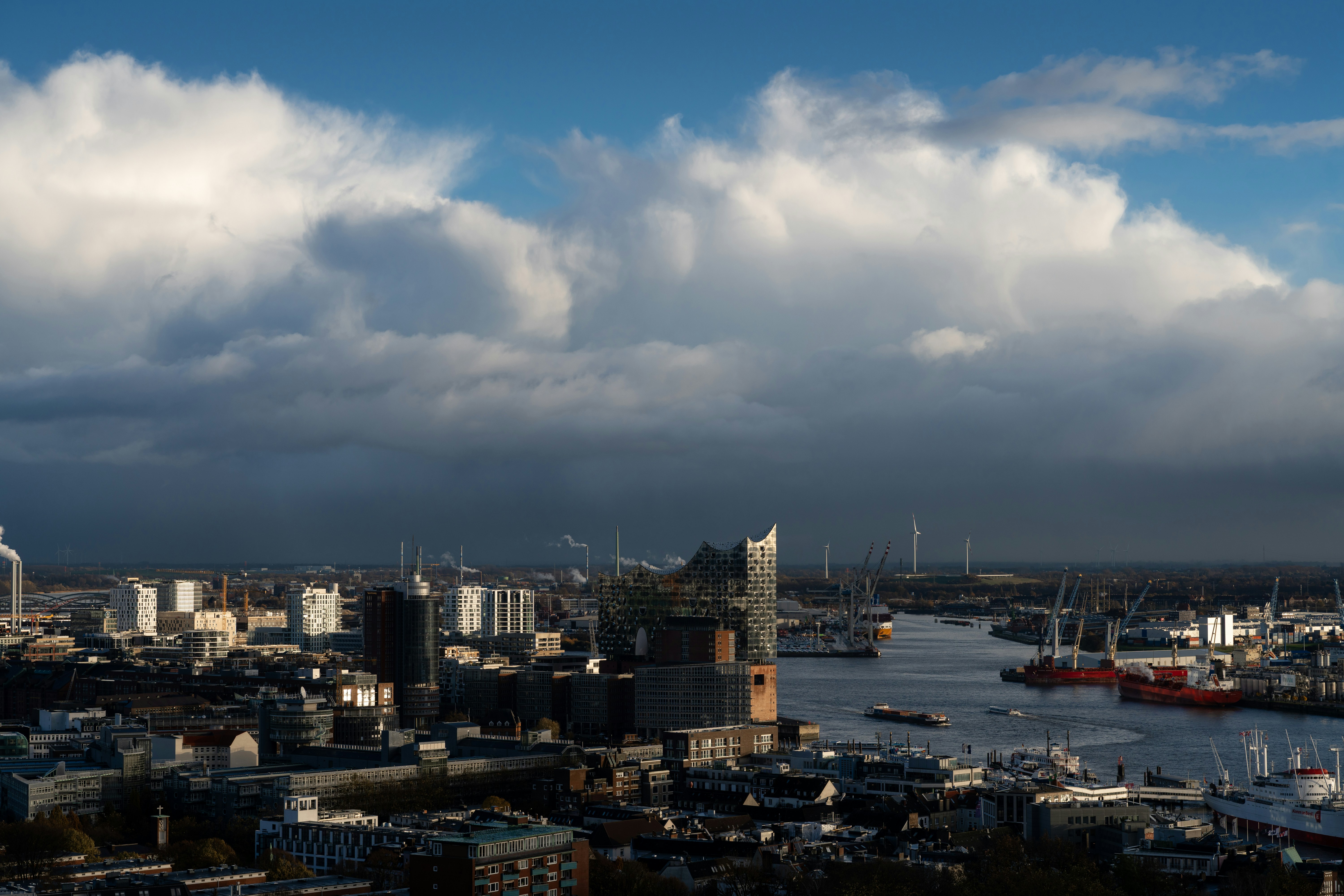 Cityscape under a cloudy sky and sunlight.