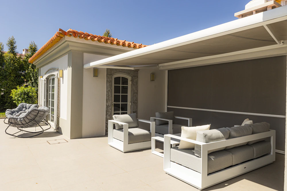 Toldo retráctil sobre una terraza con muebles de exterior