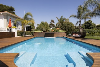 A luxurious swimming pool in a beautiful yard.