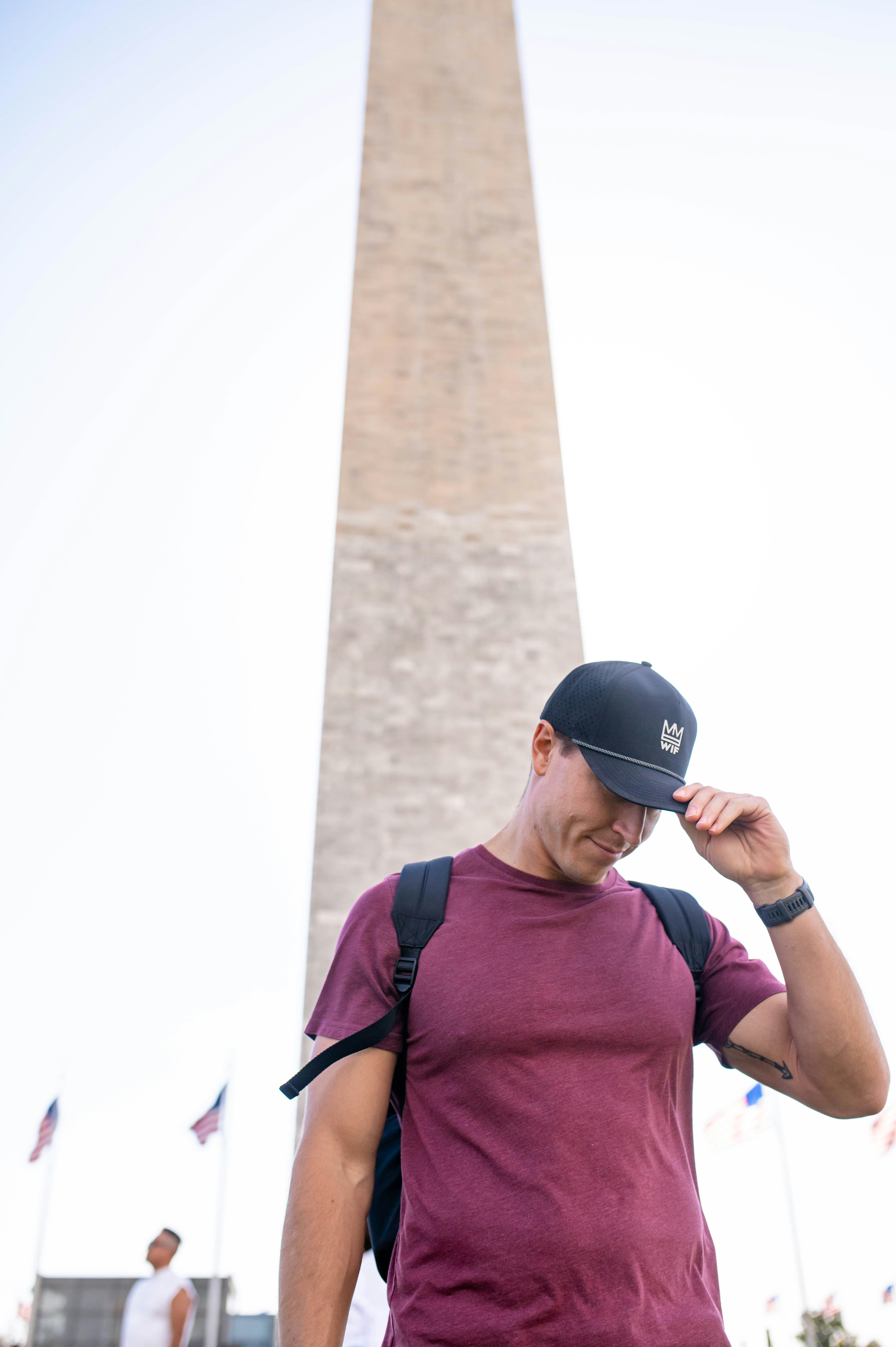 Man poses in front of the washington monument.