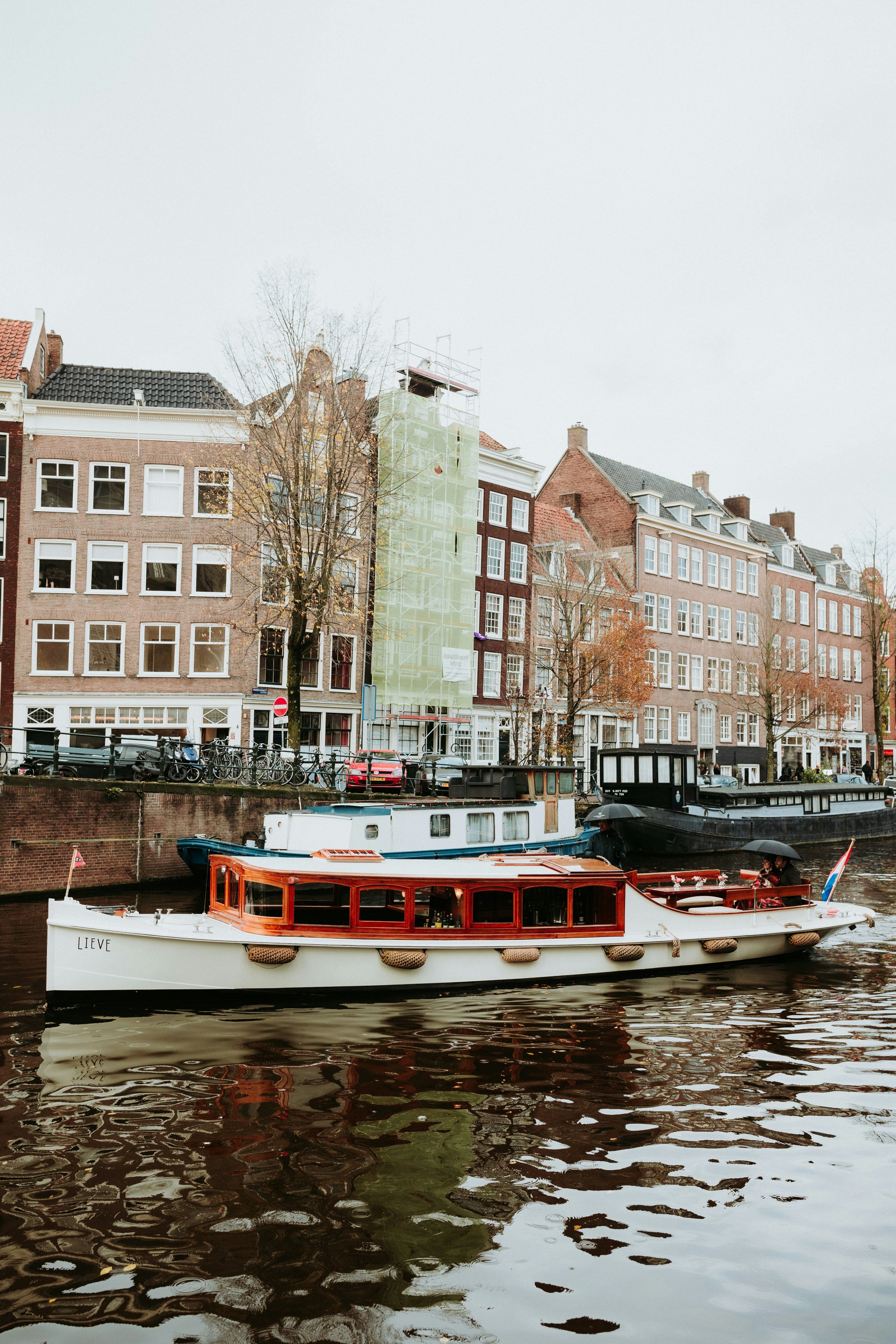 Boats float in the canals of amsterdam.