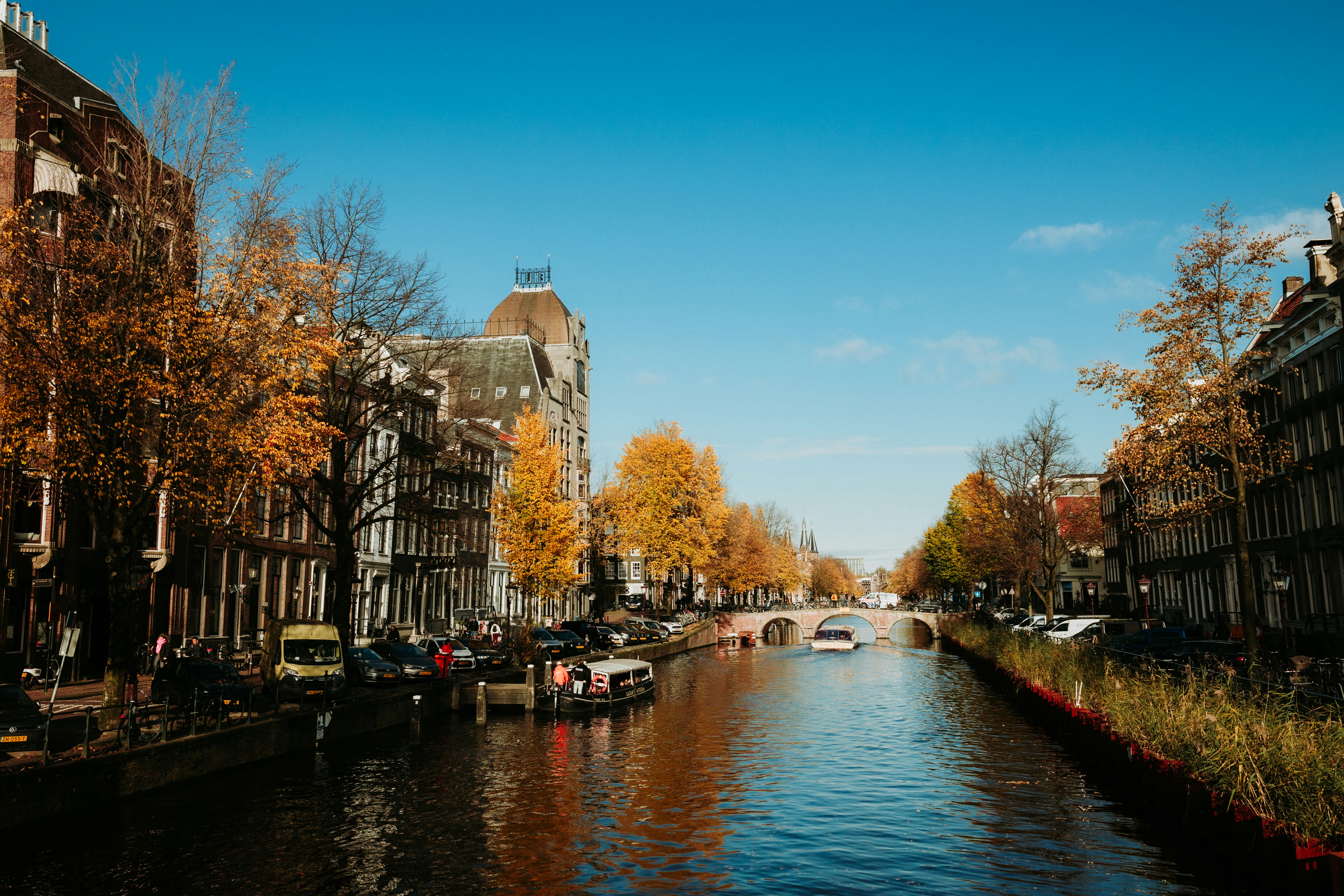 Amsterdam canal scene with buildings and boats.