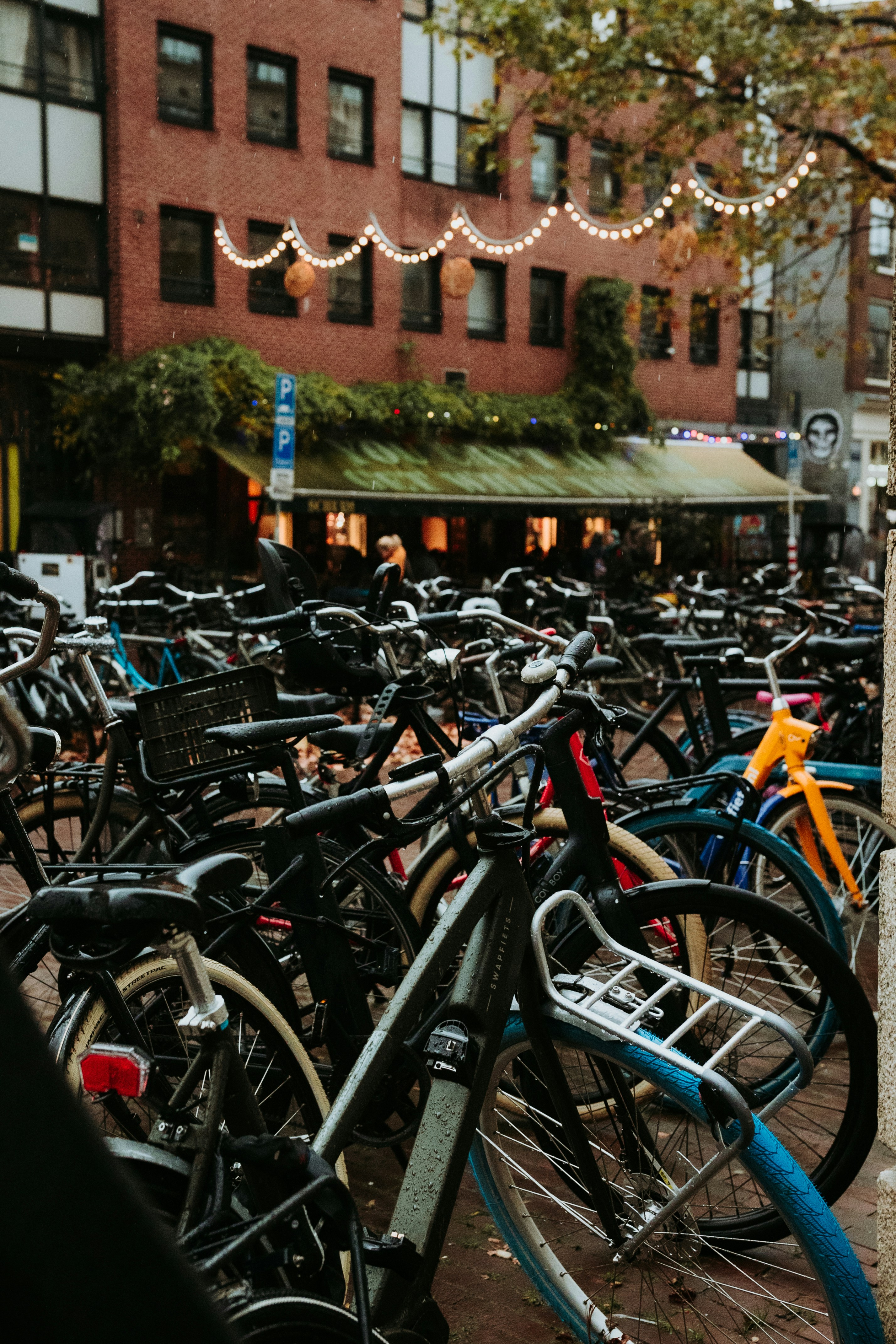 Bicycles parked in front of a cafe in amsterdam.