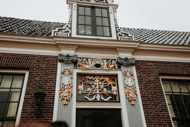 An ornate dutch building facade with detailed architectural elements.