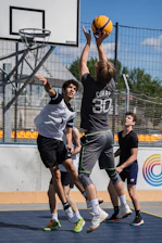 Basketball player shoots for the hoop during the game.
